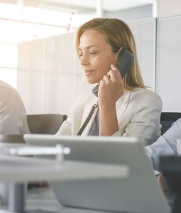 saleswoman in white blazer on a sales call
