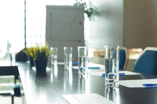 boardroom table with glasses of water