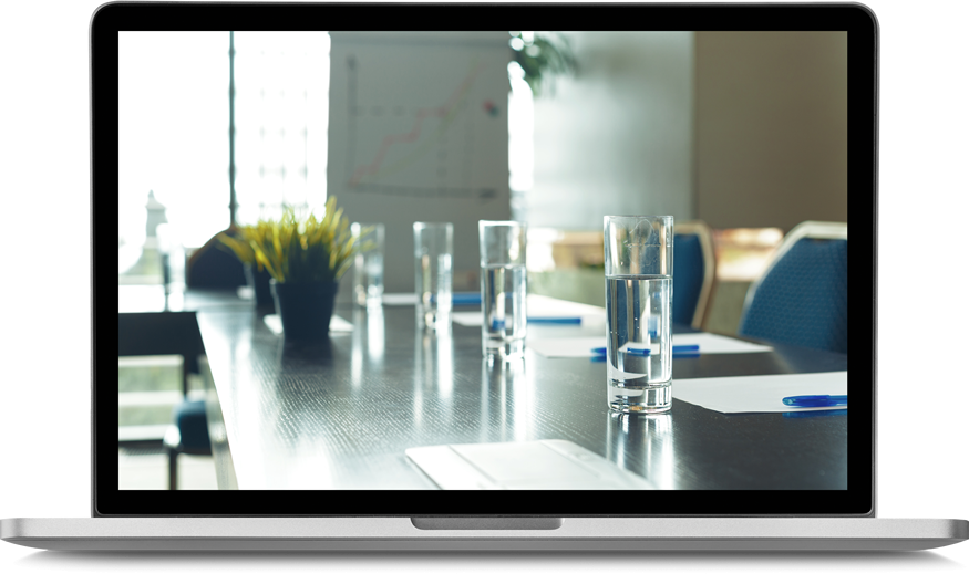 laptop screen featuring a boardroom table with water glasses